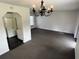 Dining area with chandelier and kitchen access at 12026 Boynton Ln # Gb32, New Port Richey, FL 34654
