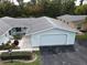 Aerial view of a light blue home with a garage and landscaped yard at 12026 Boynton Ln # Gb32, New Port Richey, FL 34654