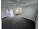 Living room with grey carpeting and access to a screened patio at 12026 Boynton Ln # Gb32, New Port Richey, FL 34654