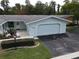 Condo exterior with attached garage and landscaping at 12026 Boynton Ln # Gb32, New Port Richey, FL 34654
