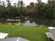 Peaceful view of a canal from the property, lush green grass in the foreground at 12026 Boynton Ln # Gb32, New Port Richey, FL 34654