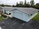 Aerial view of a light blue home with a garage and well-maintained yard at 12026 Boynton Ln # Gb32, New Port Richey, FL 34654