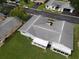 Aerial view showing a single-story home's roofline, backyard, and screened porch at 12026 Boynton Ln # Gb32, New Port Richey, FL 34654