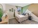 Bright bedroom with a double bed and geometric accent wall at 712 Ace Outlaw Ave, Ruskin, FL 33570