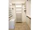 Spacious walk-in closet with ample shelving and hanging rods at 3582 Fairway Forest Dr, Palm Harbor, FL 34685