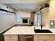 Modern kitchen with quartz countertops and stainless steel appliances at 3582 Fairway Forest Dr, Palm Harbor, FL 34685