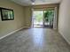Bright bedroom with tiled floors and sliding glass doors leading to the pool at 3582 Fairway Forest Dr, Palm Harbor, FL 34685