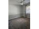 Bedroom with gray carpet, ceiling fan and window with gray curtains at 3582 Fairway Forest Dr, Palm Harbor, FL 34685