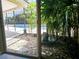 Relaxing view of the pool and garden from the house at 3582 Fairway Forest Dr, Palm Harbor, FL 34685