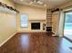 Living room featuring a stone fireplace and dark wood floors at 3582 Fairway Forest Dr, Palm Harbor, FL 34685