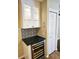 Kitchen wet bar with wine cooler and glass-front cabinets at 3582 Fairway Forest Dr, Palm Harbor, FL 34685