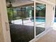 Sliding glass doors that open to a view of a refreshing pool at 3582 Fairway Forest Dr, Palm Harbor, FL 34685