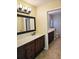 Double vanity bathroom with dark wood cabinets and quartz countertops at 3582 Fairway Forest Dr, Palm Harbor, FL 34685