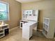 Home office with white corner desk, shelving unit and window at 3582 Fairway Forest Dr, Palm Harbor, FL 34685