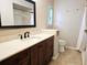 Bathroom with dark wood vanity, quartz countertop, and walk-in shower at 3582 Fairway Forest Dr, Palm Harbor, FL 34685