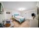 Bedroom with teal bed frame, workspace, and tiled floor at 250 Rosery Nw Rd # 351, Largo, FL 33770