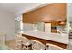Kitchen features wood cabinets, white appliances and a breakfast bar at 1400 Tarpon Woods Blvd # B5, Palm Harbor, FL 34685