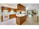 Functional kitchen with wood cabinets and breakfast bar at 1400 Tarpon Woods Blvd # B5, Palm Harbor, FL 34685