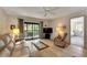 Living room with comfortable seating and view into bedroom at 1400 Tarpon Woods Blvd # B5, Palm Harbor, FL 34685