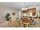Dining room with oval table, six chairs, and a view of the kitchen at 1400 Tarpon Woods Blvd # B5, Palm Harbor, FL 34685
