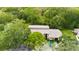 Building exterior, surrounded by mature trees and parking at 1400 Tarpon Woods Blvd # B5, Palm Harbor, FL 34685