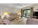 Living room with comfortable seating and sliding glass doors to balcony at 1400 Tarpon Woods Blvd # B5, Palm Harbor, FL 34685