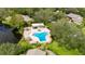 Community pool, spa and patio area, near a lake at 1400 Tarpon Woods Blvd # B5, Palm Harbor, FL 34685