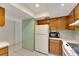 White appliances and wood cabinets in this galley-style kitchen at 1400 Tarpon Woods Blvd # B5, Palm Harbor, FL 34685