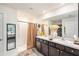 Elegant bathroom featuring double sinks, large mirror, and a shower/tub combo at 38271 Sonnet Landing Ave, Zephyrhills, FL 33540