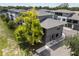 Aerial view of a modern townhouse with gray exterior and a large tree at 8723 Palm Ranches Pl, Tampa, FL 33614