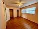Bedroom with double closets, wood-look floors, and windows at 2525 W Bay Dr # B32, Largo, FL 33770