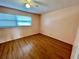 Bedroom with wood-look flooring and windows at 2525 W Bay Dr # B32, Largo, FL 33770