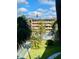 View of community pool, shuffleboard courts, and lush landscaping at 2525 W Bay Dr # B32, Largo, FL 33770