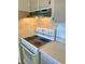Close-up of the kitchen's white electric range and tile backsplash at 2525 W Bay Dr # B32, Largo, FL 33770