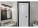 Clean and updated bathroom with a shower and granite countertop at 402 E Emma St, Tampa, FL 33603