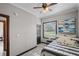 Comfortable bedroom with a striped bedspread and large window at 402 E Emma St, Tampa, FL 33603