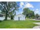 Gray house with a side yard and lawn at 402 E Emma St, Tampa, FL 33603