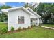 Small gray house with a front porch and landscaped yard at 402 E Emma St, Tampa, FL 33603