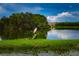 Serene lake view with a bird and lush vegetation at 6450 Shoreline Dr # 9405, St Petersburg, FL 33708