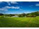 Landscaped lawn with a pond and seating area at 6450 Shoreline Dr # 9405, St Petersburg, FL 33708