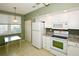 Kitchen boasts white cabinets, granite counters, and breakfast nook at 6450 Shoreline Dr # 9405, St Petersburg, FL 33708