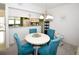 Charming dining area with a white table and teal chairs at 6450 Shoreline Dr # 9405, St Petersburg, FL 33708