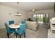 Living room with dining area, sofa, and access to balcony at 6450 Shoreline Dr # 9405, St Petersburg, FL 33708