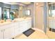 Double vanity bathroom with white cabinets and shower at 6450 Shoreline Dr # 9405, St Petersburg, FL 33708