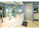 Bathroom with double sinks, white cabinets, and a shower at 6450 Shoreline Dr # 9405, St Petersburg, FL 33708