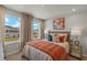 Bright bedroom with large windows and orange bedding at 31564 Woodland Race Loop, Wesley Chapel, FL 33545
