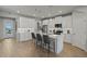Modern kitchen with white cabinets, quartz countertops, and a large island at 31564 Woodland Race Loop, Wesley Chapel, FL 33545
