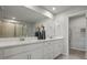 Double vanity bathroom with modern finishes and a large mirror at 31564 Woodland Race Loop, Wesley Chapel, FL 33545