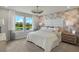 Main bedroom with large windows, a stunning view, and an ensuite bathroom at 31564 Woodland Race Loop, Wesley Chapel, FL 33545