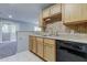 Clean kitchen with light wood cabinets and black appliances at 15215 Amberly Dr # 206, Tampa, FL 33647